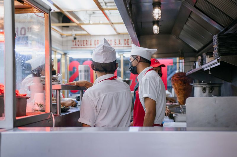Wing Snob kitchen team preparing food in action